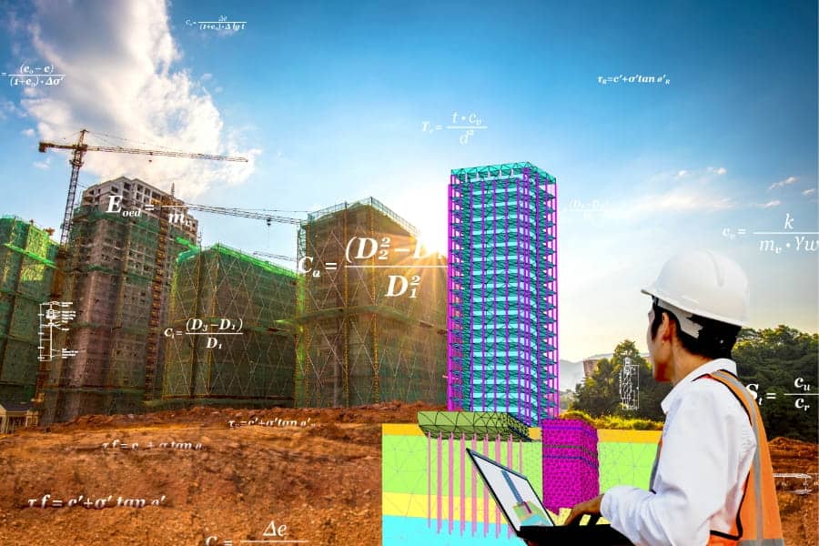 Engineer with a laptop analyzing construction site progress with mathematical calculations and structural designs superimposed on the image.