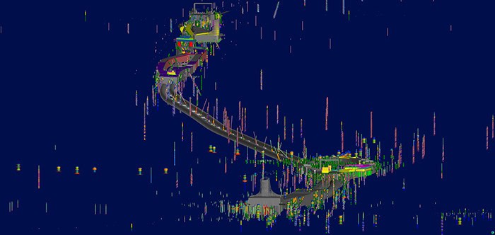 A digitally altered image of a winding road with buildings, shown with visual distortions and vertical streaks on a dark blue background.