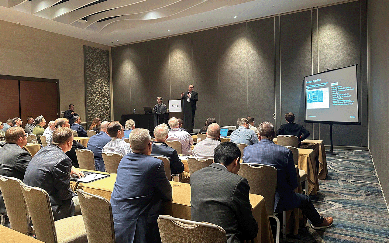 A group of people seated in a conference room listens to a presenter at the podium, with a presentation projected on screen during the AEC Fall Conference 2025