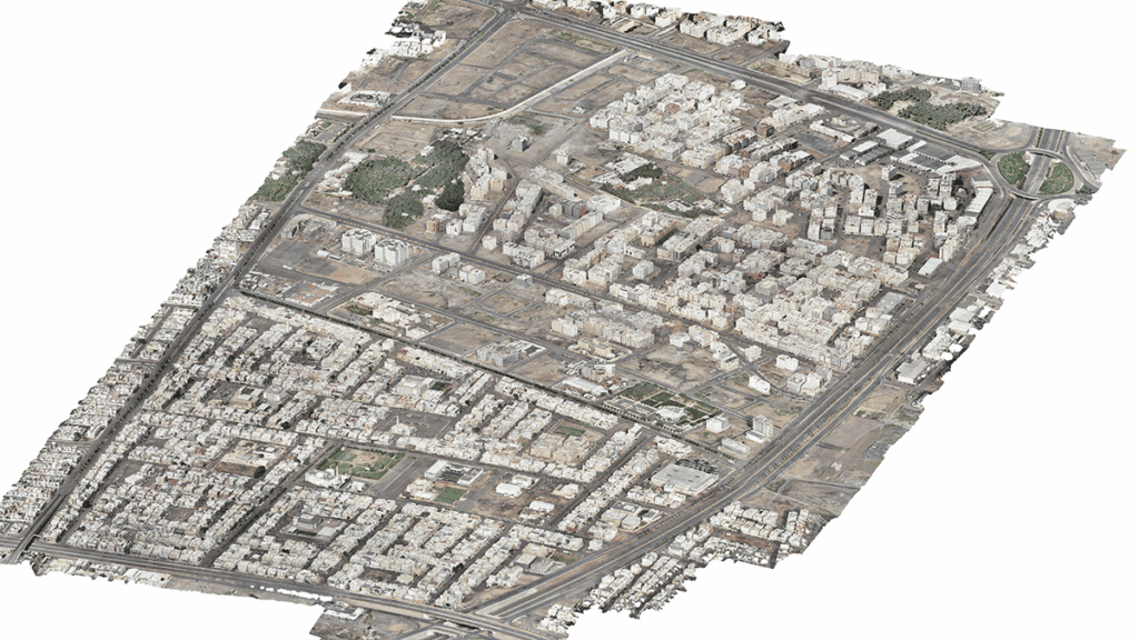 Aerial view of Madinah smart city with dense buildings, roads, and sparse green spaces, highlighting a mix of residential and commercial structures as part of the MDA YII Project.