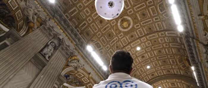 A surveyor with a balloon equipped with cameras inside St. Peter's Basilica