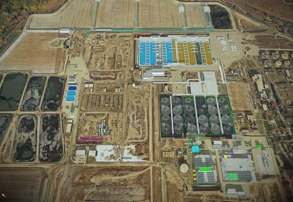 Aerial view of an industrial facility showcasing large storage tanks, buildings, rectangular ponds, pipelines, and surrounding construction areas—ideal for optimizing site design or creating accurate digital twins.