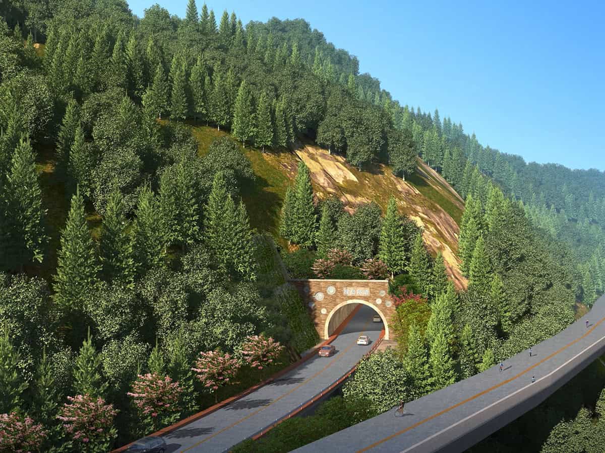 A forested mountainside features the entrance to the “Hieu Trung” tunnel, where several cars enter beneath an elevated roadway—part of an ecological highway by PowerChina ZhongNan Engineering for the YII project.