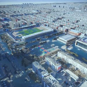 Aerial view of a city in Northwest China with partially flooded streets and buildings, including a stadium, residential blocks, and commercial areas, showcasing the need for smart flood control through digital innovation.