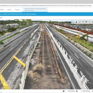A digital 3D point cloud model of a multi-lane highway under construction is displayed in a roadway design software interface, enabling advanced data management for accurate transport reality visualization.