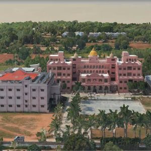 Aerial view of a large pink building with a yellow dome, surrounded by trees, smaller buildings, and an open courtyard—an iconic architectural feature often found in India. This striking scene provides valuable context for geospatial data and city-scale data management applications.