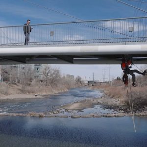 construction worker under pedestrian bridge