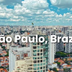 Aerial view of São Paulo, Brazil, featuring tall buildings, residential areas, and a partly cloudy sky. Text "São Paulo, Brazil" is overlaid on the image, highlighting Sabesp’s role in smart water solutions for the city.