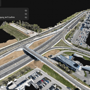3D rendered aerial view of a highway interchange with multiple roads, parking lots, cars, and a building; menu overlay present in the upper left corner.