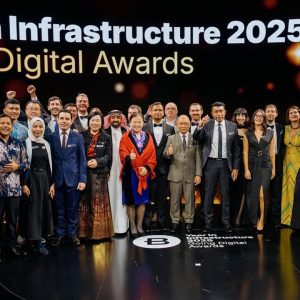 A large group of people pose on stage under the āYear in Infrastructure 2025 Going Digital Awardsā sign, dressed in formal and semi-formal attire, celebrating achievements in Best in Infrastructure. A large group of people pose on stage under the āYear in Infrastructure 2025 Going Digital Awardsā sign, dressed in formal and semi-formal attire, celebrating achievements in Best in Infrastructure.