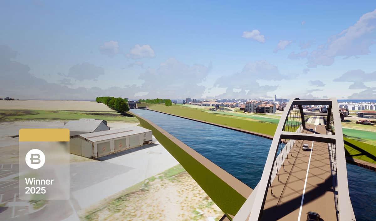 A bridge, part of a major infrastructure project, carries vehicles over a wide canal with fields on one side and a cityscape in the background; a "Winner 2025" badge is visible in the corner.