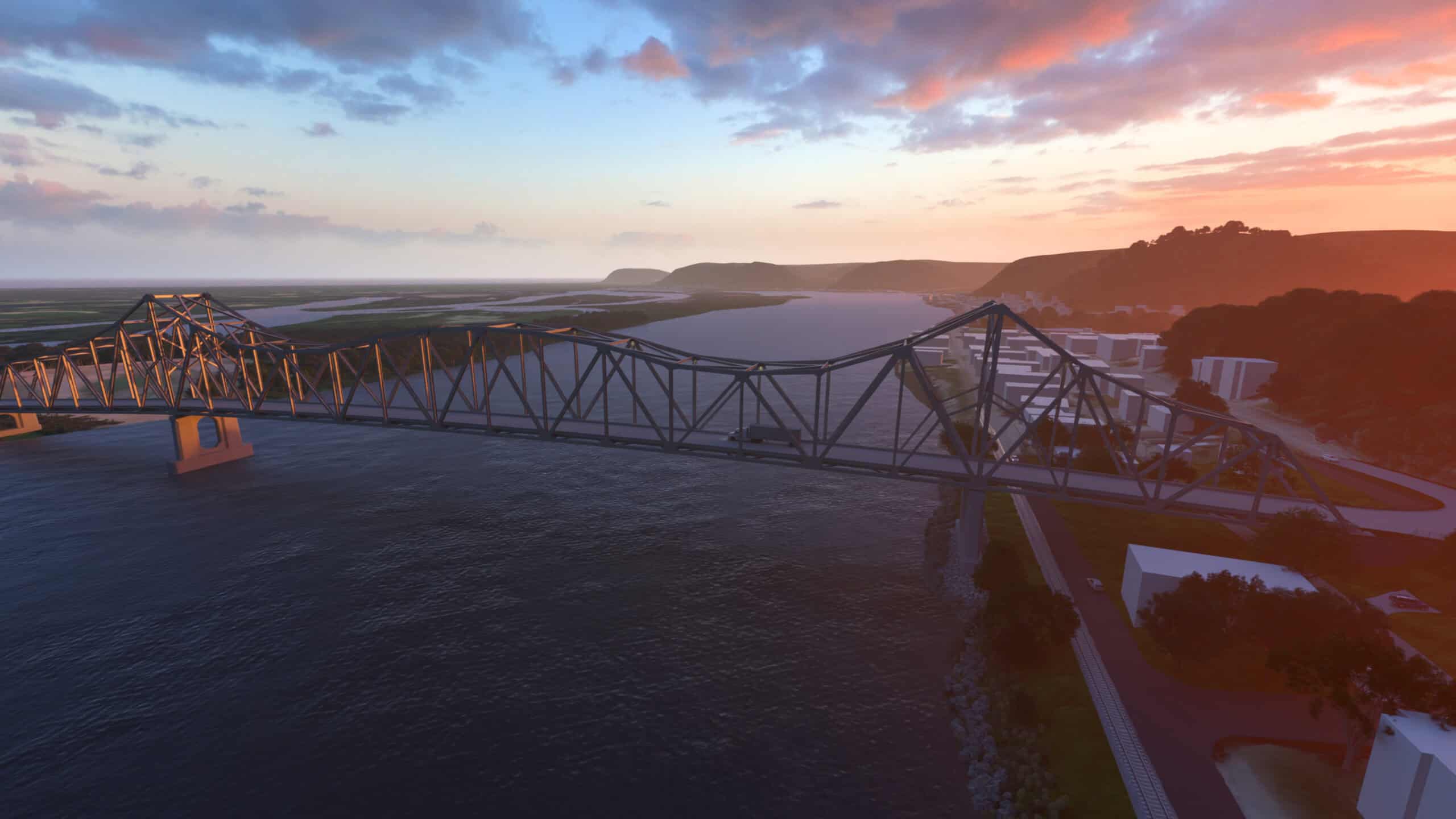 A large steel truss bridge spans a wide river at sunset, with vehicles crossing and hills in the background—a scene that captures the simpler way of getting started with ProjectWise infrastructure.