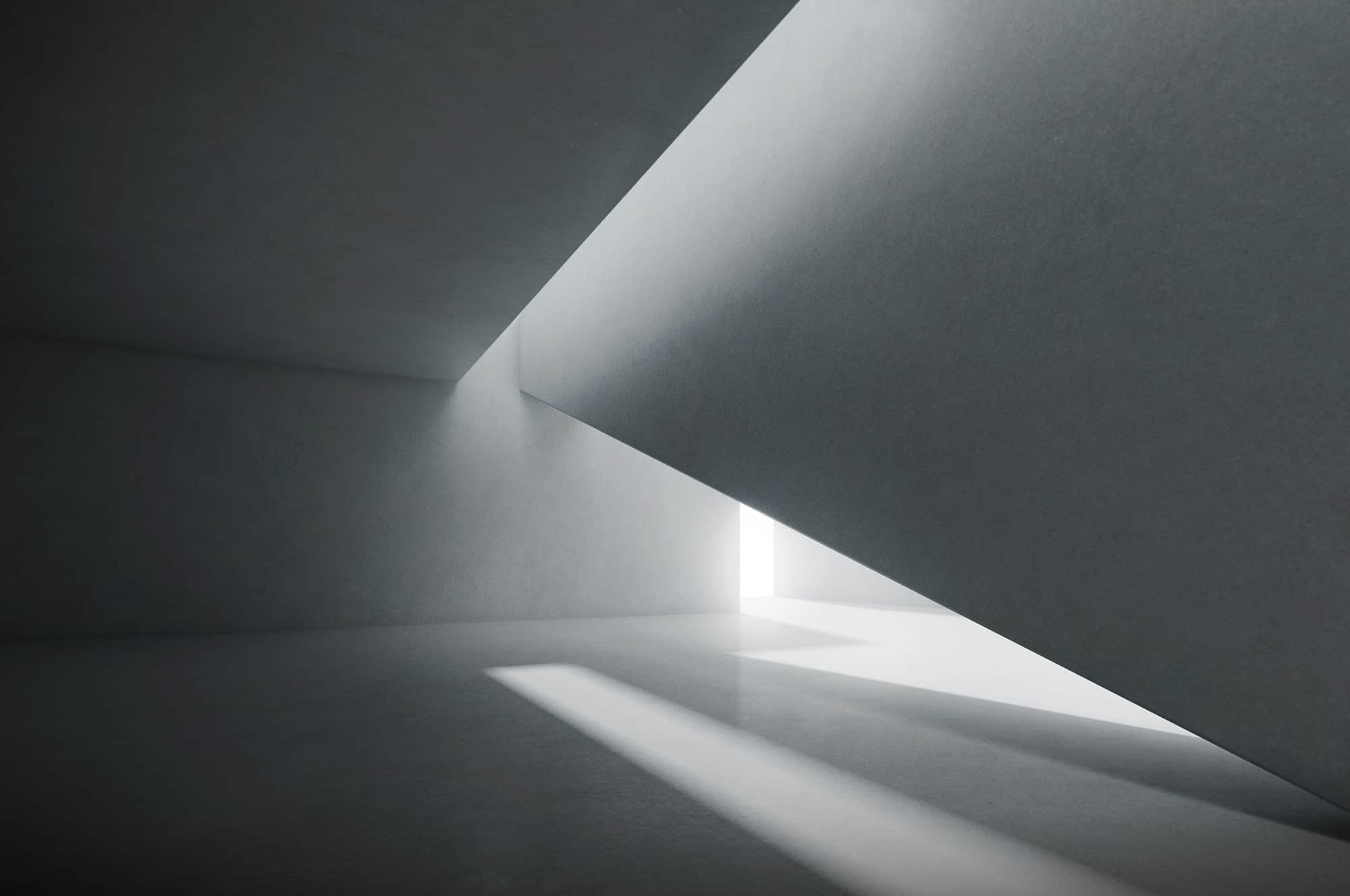 Abstract architectural interior with natural light casting geometric shadows.