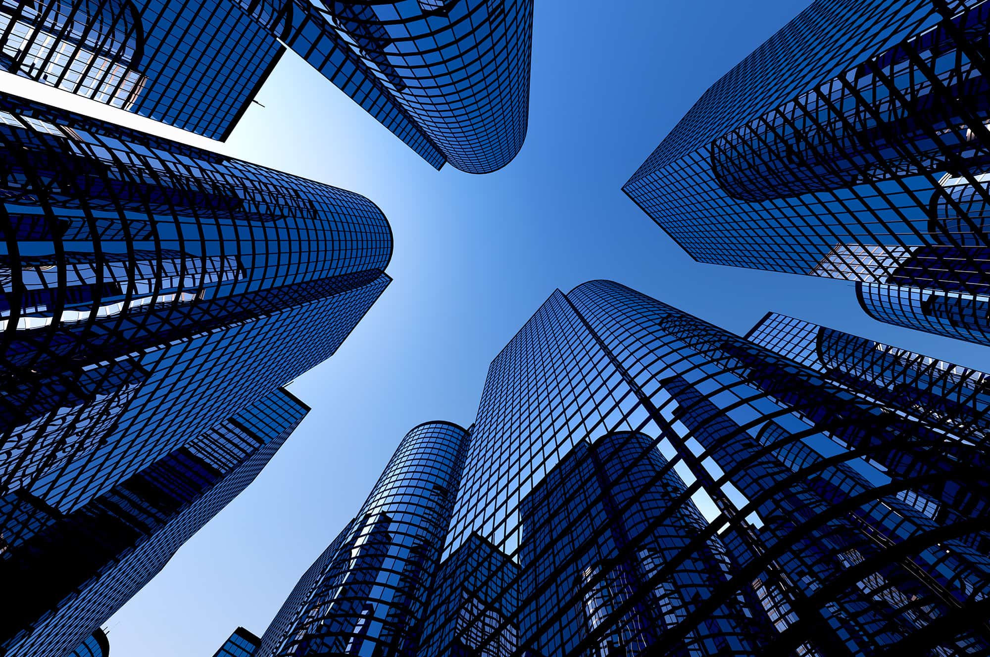 Skyscrapers reaching towards a clear blue sky, forming a cross-shaped negative space at the center.