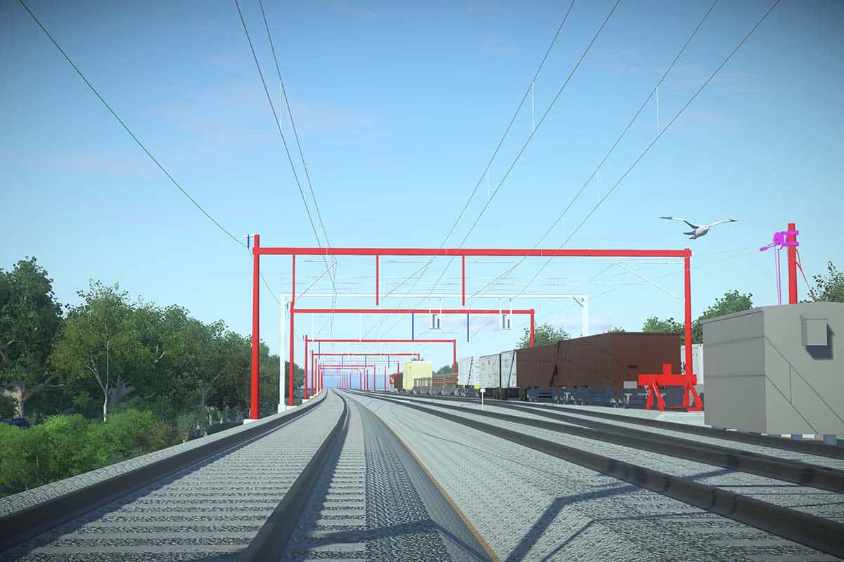 Railway tracks extend into the distance with red overhead electrical lines, adjacent freight cars, green trees, and a blue sky with a flying bird.