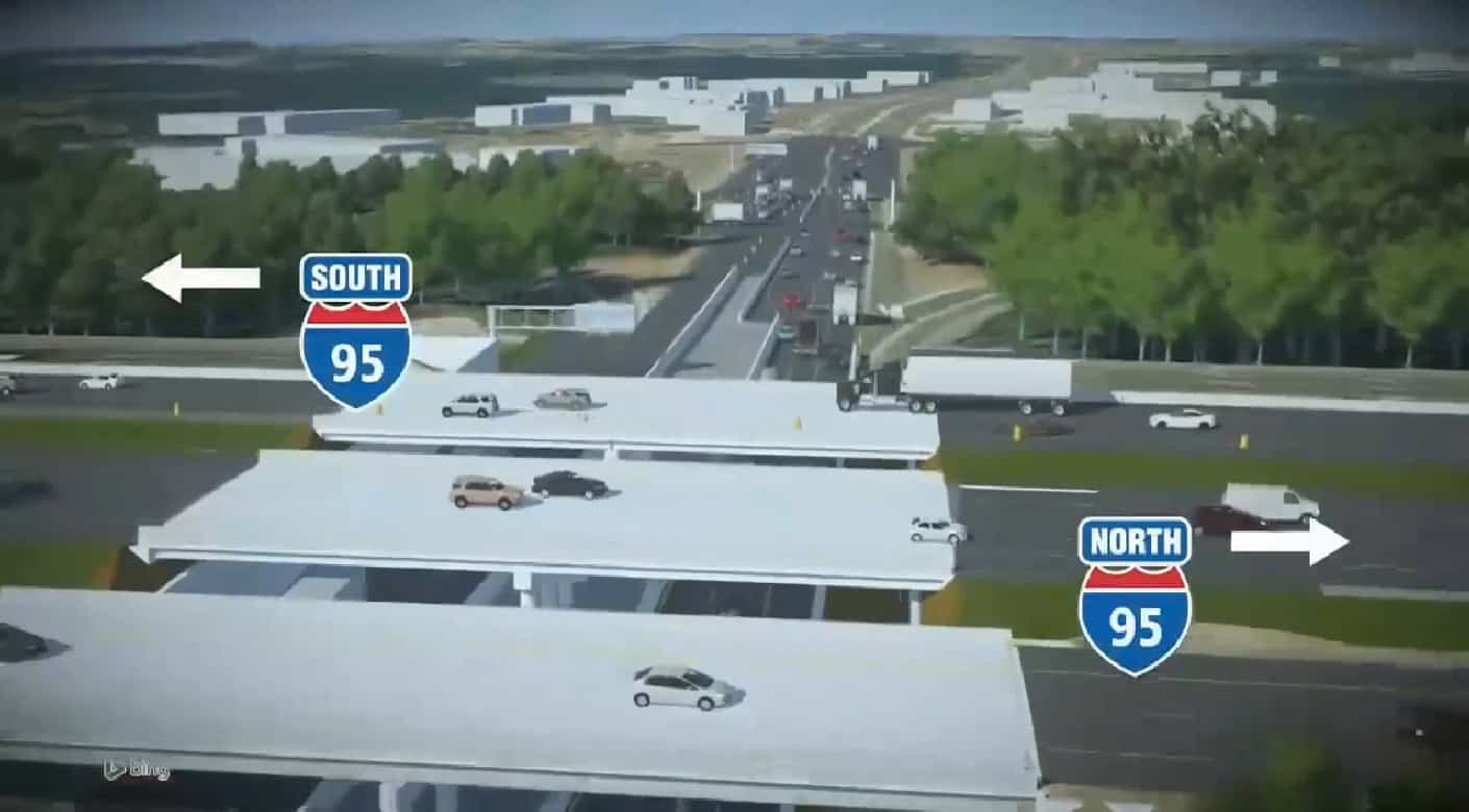 A highway overpass with cars traveling in both directions, labeled signs indicate I-95 South to the left and I-95 North to the right; trees and buildings are in the background.