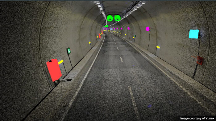 A tunnel interior displaying various colored markers and signage along the walls and ceiling, used for testing and analysis purposes.