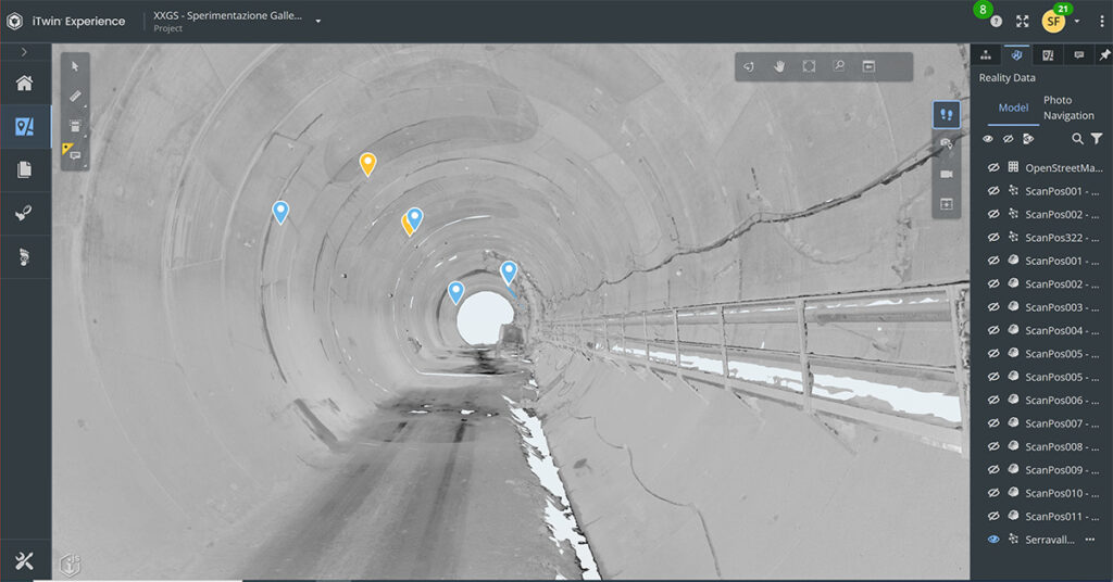 A grayscale 3D model of a tunnel is displayed on a digital platform interface, with colored map markers indicating key points of interest—showcasing Italferr S.p.A.’s award-winning expertise in Bridges and Tunnels as a YII Winner.