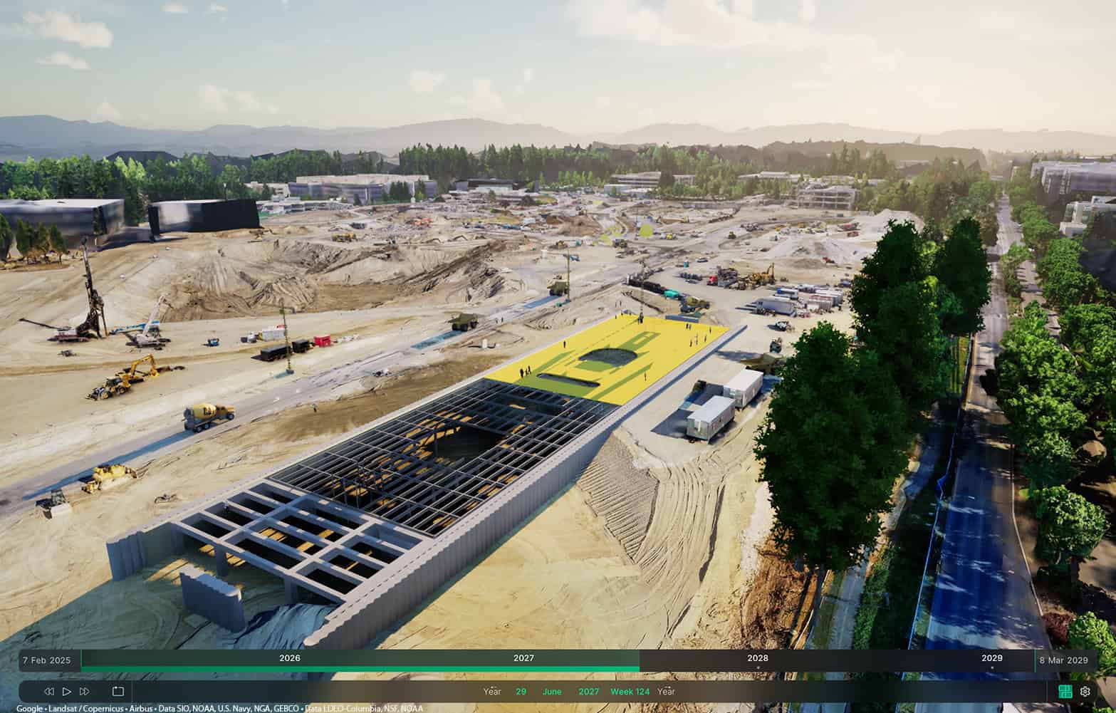A large construction site with a partially built structure in the center, surrounded by machinery, equipment, and cleared land under a partly cloudy sky—showcasing modern design and the use of digital twins in construction.