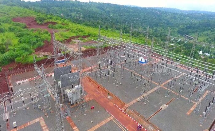 An overhead view of an electrical substation surrounded by green hills in Cameroon.