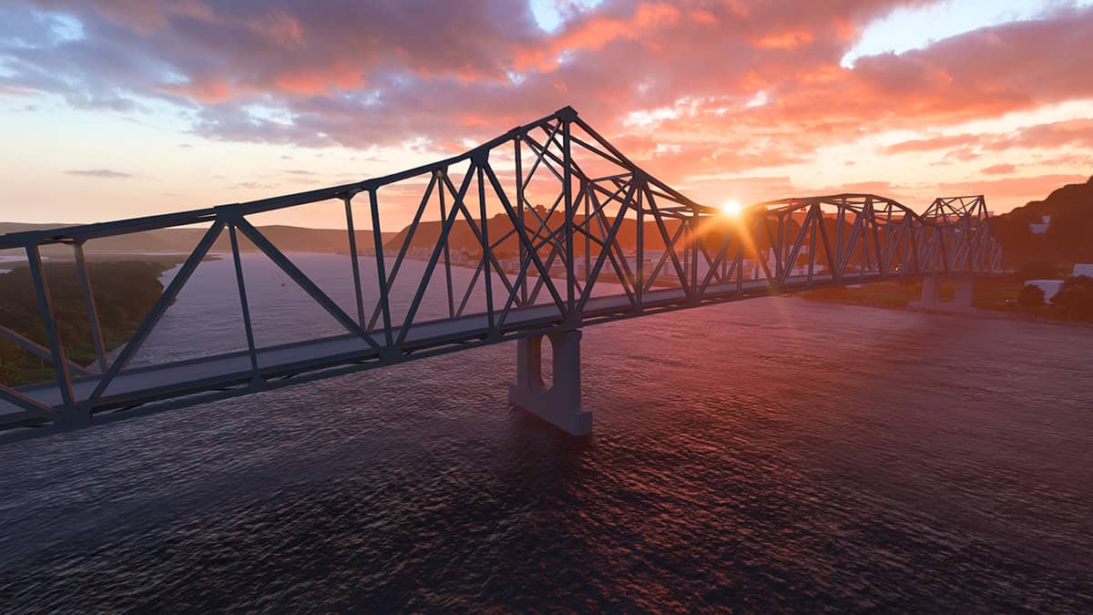 A steel truss bridge, expertly crafted using Bridge Design principles, crosses a wide river at sunset, with the sun partially visible near the horizon and clouds scattered across the sky.