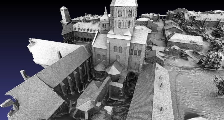 3D grayscale point cloud model of a historic architectural complex with multiple buildings, arches, and a large central tower viewed from above, showcasing how machines see in 3D for reconstructing reality.