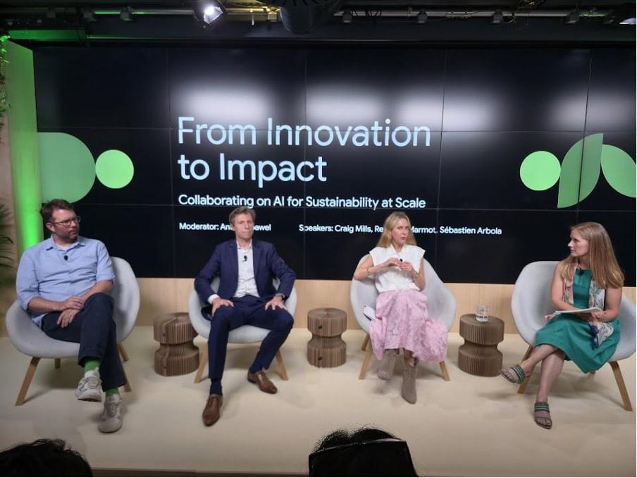 Four panelists sit on stage during a discussion titled "From Innovation to Impact: Collaborating on AI for Earth and Sustainability at Scale," with names and roles displayed on the screen behind them.