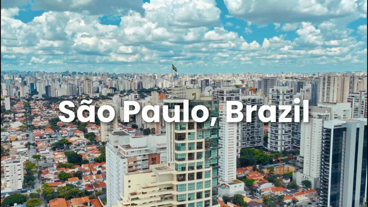 Aerial view of São Paulo, Brazil, featuring tall buildings, residential areas, and a partly cloudy sky. Text "São Paulo, Brazil" is overlaid on the image, highlighting Sabesp’s role in smart water solutions for the city.