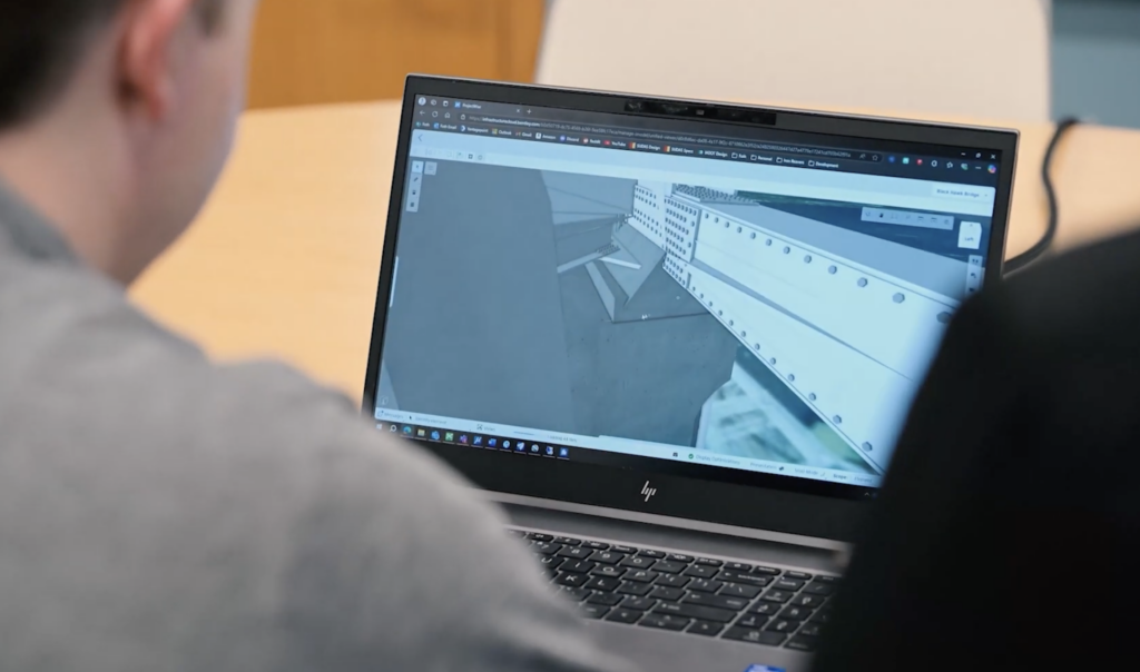 Two engineers viewing the digital model of the Black Hawk Bridge on ProjectWise.