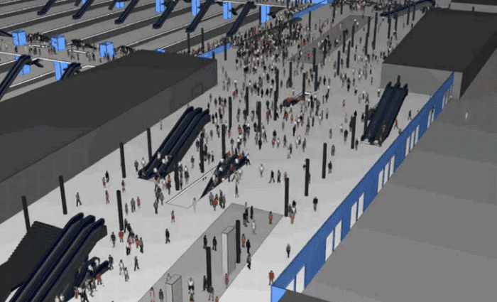 A digital rendering shows a crowded transportation terminal with many people, escalators, and several platform areas visible.