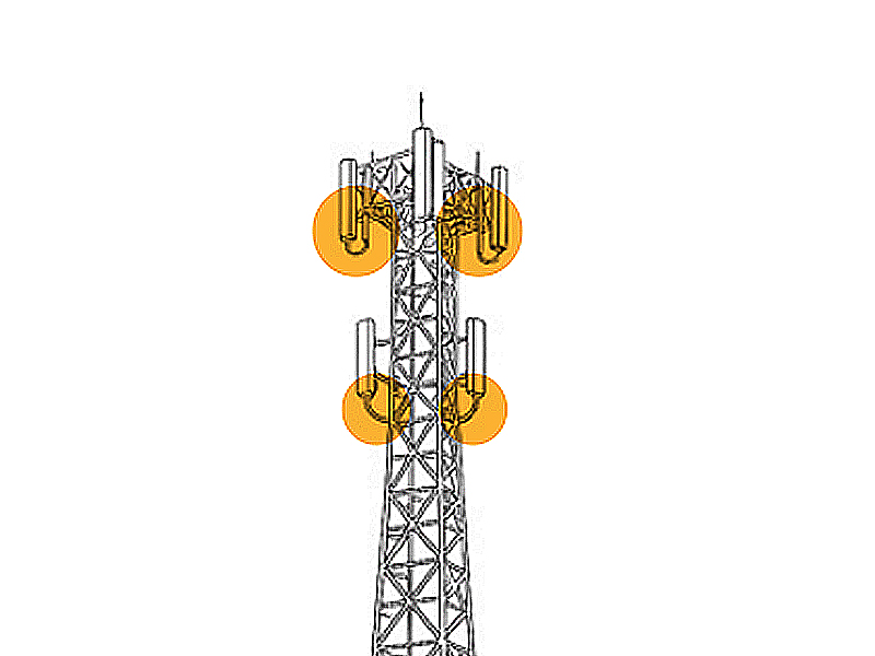 Line drawing of a tall metal tower with two orange circles, highlighting a small shed and a larger building with equipment at the base—perfect for those who want to Know Your Tower.