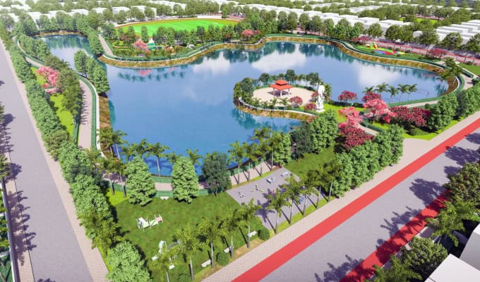 Aerial view of Atal Puram Township’s landscaped park featuring a large, irregularly shaped lake, tree-lined paths, a pavilion on an island, green lawns, and surrounding roads—an example of Advanced Design Tools by Voyants Solutions.