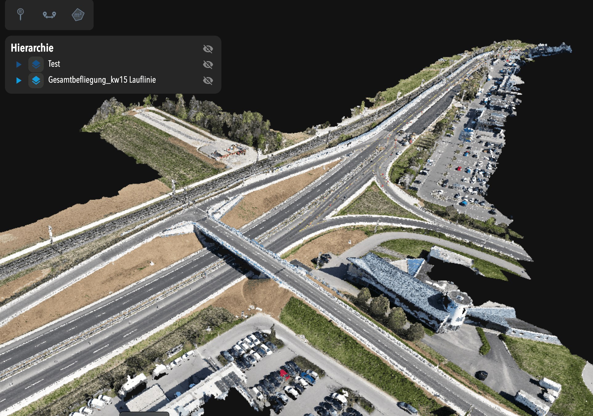 3D rendered aerial view of a highway interchange with multiple roads, parking lots, cars, and a building; menu overlay present in the upper left corner.