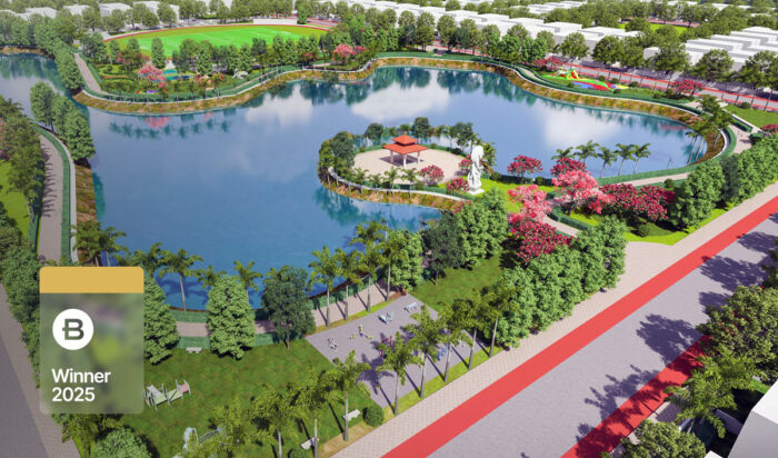 A landscaped park in Atal Puram Township features a large lake, walking paths, trees, a pavilion, and sculpture; a "B Winner 2025" badge by Voyants Solutions appears in the lower left corner.