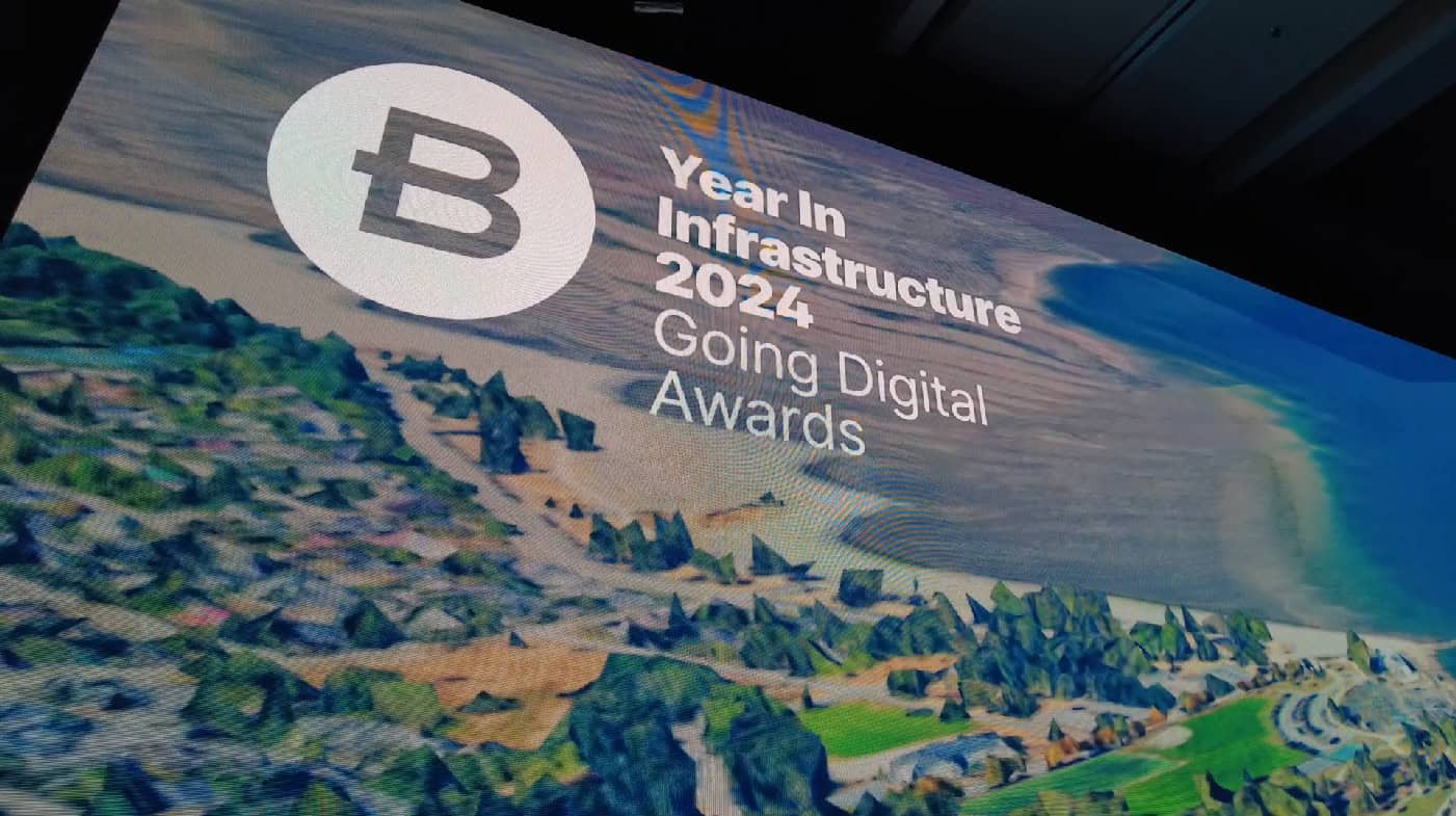 Presentation slide showing the "Year in Infrastructure 2024: Going Digital Awards" with a backdrop of a coastal landscape.