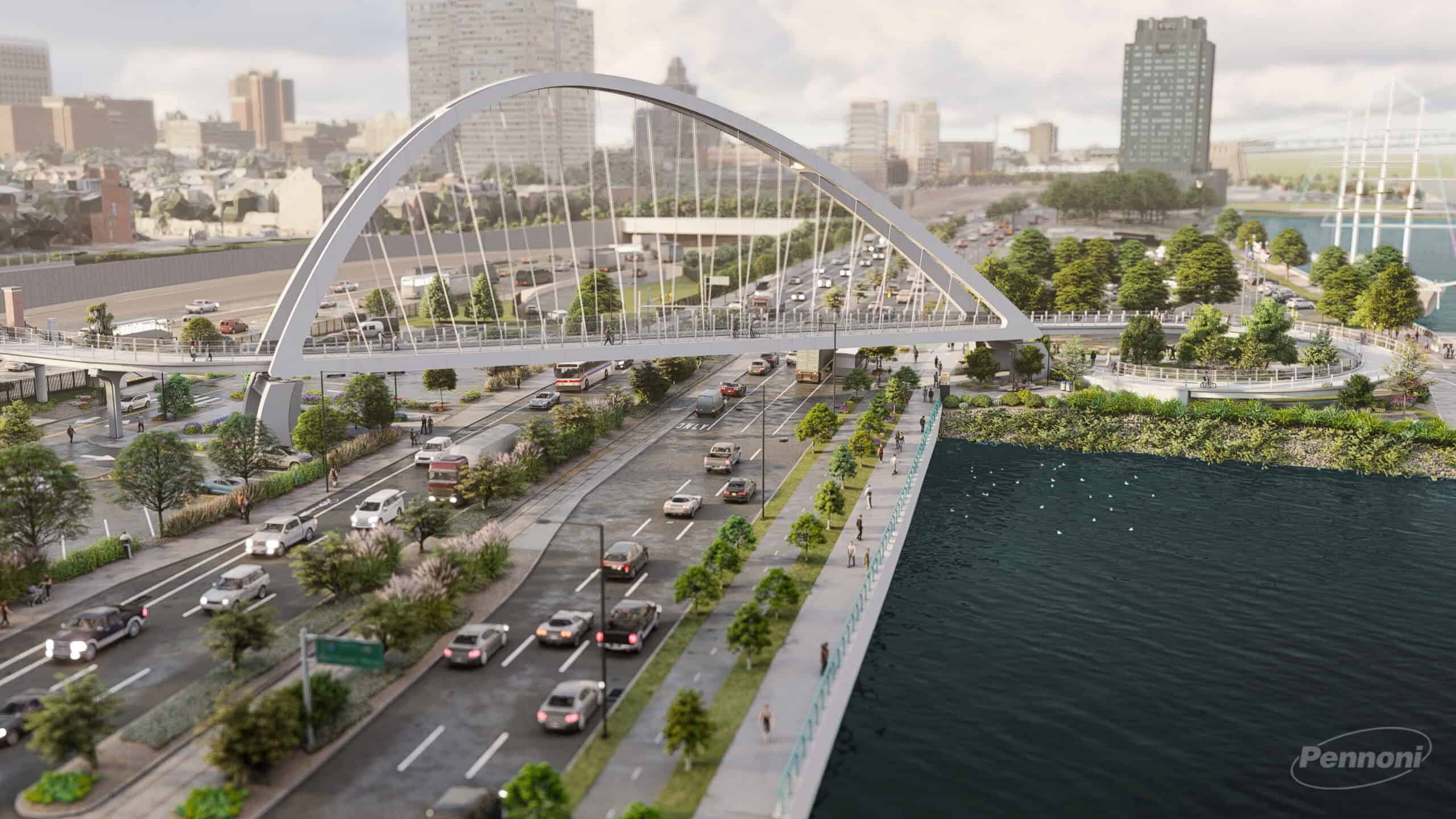 A wide bridge with arch supports, part of a YII Project, spans over busy multi-lane roads beside a waterfront, with city buildings and greenery in the background.