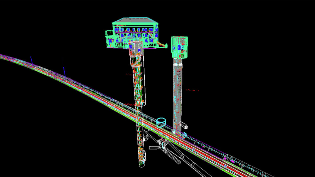 A 3D digital twin model shows a building, two vertical structures, and a slanted pathway with colorful wireframe lines on a black background—perfect for Network Rail project visualization.